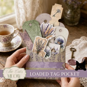May include: A loaded tag pocket featuring a lavender-themed paper envelope filled with decorative tags, including illustrations of lavender sprigs, a vintage key, and a birdhouse. The pocket is decorated with purple floral patterns and text.