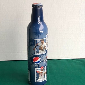 May include: A blue aluminium Pepsi can with a baseball theme. It features images of baseball players, including Albert Pujols and Dustin Pedroia, with the text "All-Star Game 2008".