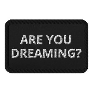 May include: Black embroidered patch with white text that reads "ARE YOU DREAMING?"
