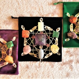 May include: Three velvet pouches with a crystal grid inside each. The pouches are green, black, and purple. The crystal grids are made of clear quartz crystals, amethyst, rose quartz, citrine, carnelian, and other crystals.