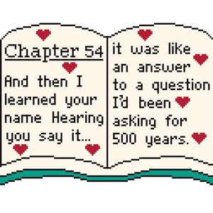 May include: An open book with a teal cover and white pages. The text on the pages reads "Chapter 54 it was like an answer to a question I'd been asking for 500 years." There are red hearts scattered throughout the text.