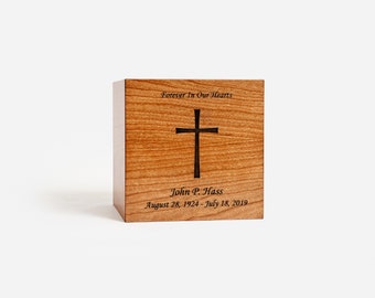 May include: A wooden box with a cross cutout and the inscription "Forever In Our Hearts" and "John P. Hass August 28, 1924 - July 18, 2019".