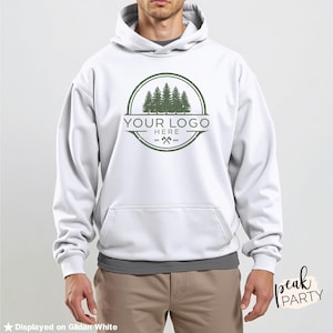 May include: White hooded sweatshirt with a front pocket and a green logo featuring trees and the text "YOUR LOGO HERE". The sweatshirt is displayed on Gildan White.