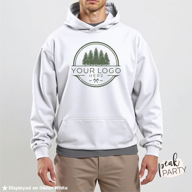 May include: White hooded sweatshirt with a front pocket and a green logo featuring trees and the text "YOUR LOGO HERE". The sweatshirt is displayed on Gildan White.