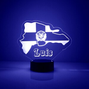 May include: A white acrylic night light shaped like the island of Puerto Rico with the name "Luis" and the Puerto Rican flag in the center.
