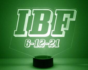May include: A green acrylic night light with the text "IBF 6-12-21" in white.
