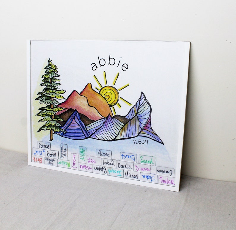May include: A watercolor painting of a mountain landscape with a sun and a pine tree. The painting is titled "abbie" and dated 11.6.21. The names of people are written below the painting.
