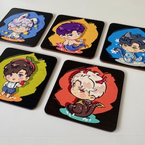 May include: Five square coasters featuring chibi-style character illustrations. Each coaster displays a unique figure: a rabbit-eared character, a mermaid, a cat-eared character, a child with a strawberry hat, and a dragon-like character with horns.