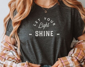 Koszulka „Let Your Light Shine”: Koszulka z grafiką w stylu „Distressed”, inspirujący krój unisex