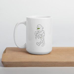 Quirky Retro Mummy Graphic Mug - Mid-Century Cartoon Style Halloween Coffee Mug - Perfect Gift for Monster Fans | White glossy mug