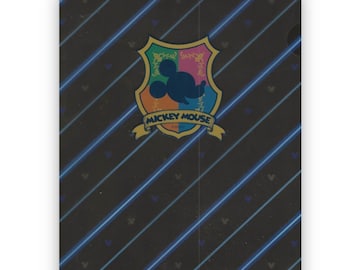 May include: A black plastic folder with a blue and white striped pattern. The folder has a Mickey Mouse logo with a colorful shield and the text "Mickey Mouse".