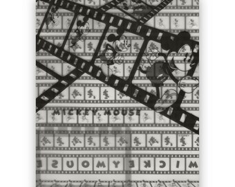 May include: Black and white image of Mickey Mouse on a clear plastic folder. The image is repeated in a grid pattern and is overlaid with film strips. The text "MICKEY MOUSE" is printed on the folder.