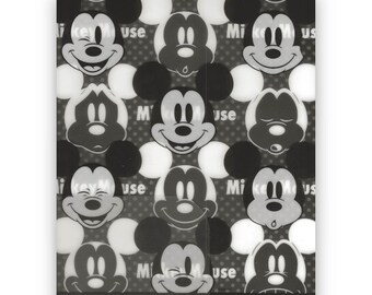 May include: Black and white plastic bag with a repeating pattern of Mickey Mouse faces. The text "Mickey Mouse" is printed on the bag.