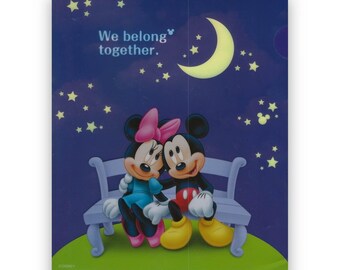 May include: Mickey Mouse and Minnie Mouse are sitting on a bench under a crescent moon and stars. The text "We belong together." is above them.