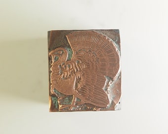 May include: A vintage copper printing block featuring a detailed relief image of a turkey.
