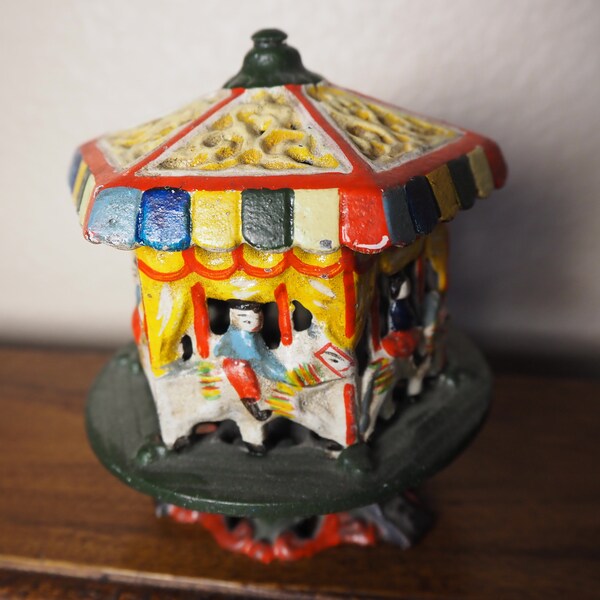 Vintage Cast Iron Spinning Carousel Merry-Go-Round Coin Bank Cast Iron Toy Complete with Bottom Plug