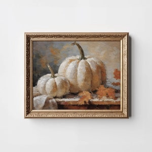 Pode incluir: Uma pintura emoldurada de duas ab&oacute;boras brancas com folhas de outono sobre uma mesa de madeira. As ab&oacute;boras s&atilde;o pintadas em um estilo realista com pinceladas sutis.