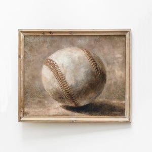 Könnte beinhalten: Ein gerahmtes Gemälde eines Baseballs, mit braunem Hintergrund und einem weißen Baseball mit braunen Nähten.