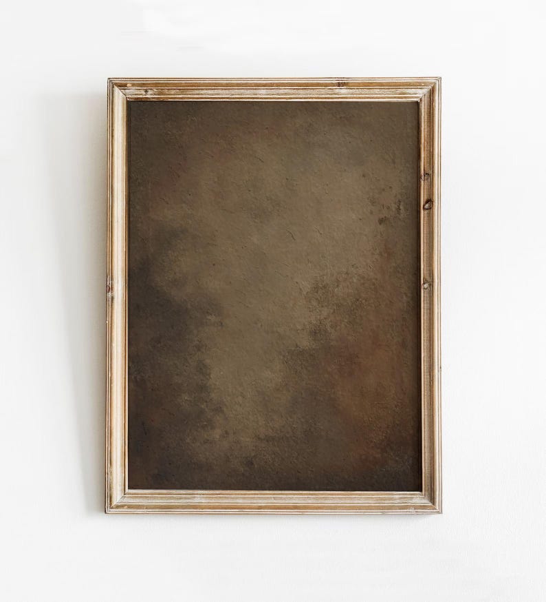 May include: A framed abstract art print with a neutral color palette. The artwork features a blend of brown and tan hues, creating a textured, painterly effect. The wooden frame adds a rustic touch to the piece.