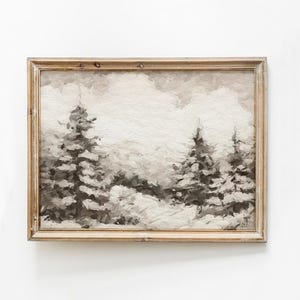 May include: A framed painting of a winter landscape with two pine trees in the foreground and a mountain range in the background. The painting is done in shades of gray and white.