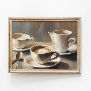 May include: A framed painting depicting a still life with three ceramic cups, two containing white liquid and one with brown liquid, on a table with a spoon. The cups are on white saucers and the background is a light brown.