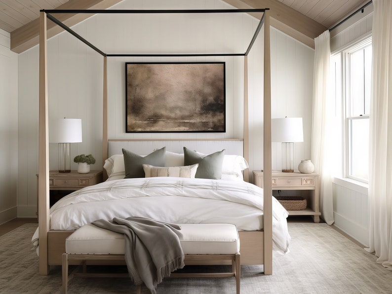May include: A white canopy bed with a wooden frame and a white headboard. The bed has a white duvet and a gray throw blanket. There are two green pillows and a patterned pillow on the bed. There are two bedside tables with lamps and a rug on the floor.