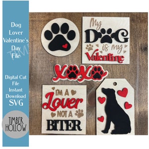 May include: A collection of wooden Valentine's Day-themed decorations for dog lovers. The designs include paw prints, hearts, and phrases like "My Dog is my Valentine" and "I'm a Lover Not a Biter." The decorations are in red, black, and natural wood tones.