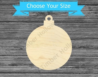 May include: A wooden Christmas ornament in a round shape with a loop at the top for hanging. The ornament is light-colored and has the text "Choose Your Size" on a blue banner. The background is a gray wood grain.