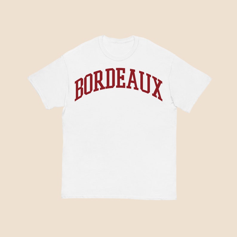 May include: White t-shirt with a red "BORDEAUX" graphic printed in an arched font.