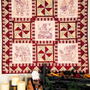 May include: A Christmas-themed quilt with embroidered Santa Claus and holiday motifs. The quilt features a patchwork design with red, cream, and green colors. The quilt is approximately 60 inches wide and 70 inches long.