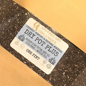 May include: A brown paper bag containing potting soil. A label reads "DRY POT PLUS" and "ONE PINT". The label also includes the words "Organic Compost & Natural Mineral" and "Premium Desert Potting, Super Soil, Extra Porous, Nutrient Rich".