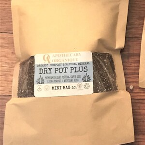May include: An arrangement featuring a small potted succulent plant and two brown paper bags of potting mix. The bags are labeled "Dry Pot Plus" and "Mini Bag 10." The larger bag is labeled "One Pint."