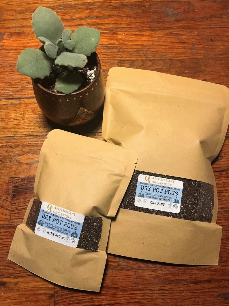 May include: A small potted succulent plant sits next to several brown paper bags of potting mix. The bags are labeled "DRY POT PLUS" and "APOTHECARY ORGANIQUE". One bag is labeled "ONE PINT" and another "MINI BAG 10."