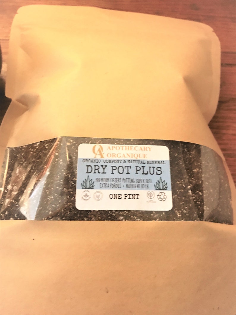 May include: A brown paper bag containing potting soil. The label reads "Dry Pot Plus" and "One Pint". The label also states that the soil is organic compost and natural mineral, premium desert potting, super soil, extra porous, and nutrient rich.