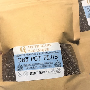 May include: Mini bags of Dry Pot Plus potting soil. The bags are brown with a blue and white label that reads "Dry Pot Plus" and "Premium Desert Potting Super Soil". The bags are labeled "Mini Bag 1c."