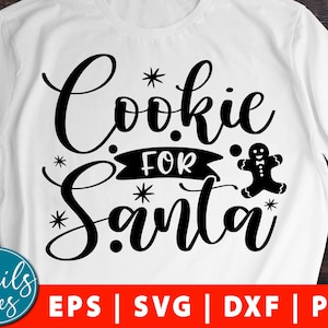 May include: A white t-shirt with black text that reads "Cookie for Santa" with a gingerbread man graphic.