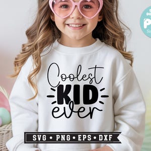 May include: A white sweatshirt with the text "Coolest KID ever" in black script. The image includes a digital download badge and a banner with "SVG &bull; PNG &bull; EPS &bull; DXF". The person in the image is wearing pink heart-shaped sunglasses.
