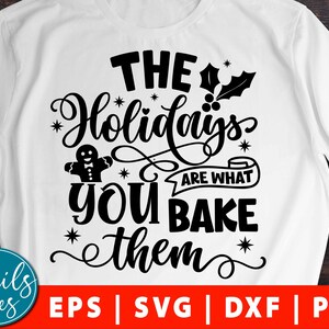 May include: Black and white graphic design with the text "The Holidays are what you bake them" with a gingerbread man illustration.  The design is on a white t-shirt.  EPS, SVG, DXF, and PNG file formats are listed below the design.
