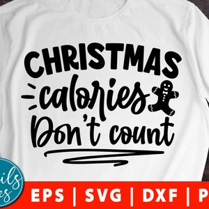 Pode incluir: Camiseta branca com texto preto que diz "Calorias de Natal não contam" e um gráfico de um homem de gengibre. O texto está em uma fonte de escrita à mão.