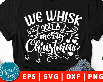 May include: Black t-shirt with white text that reads "We Whisk You A Merry Christmas". The text is in a festive font with a whisk and hearts.