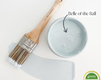 May include: A can of light blue paint with the name "Belle of the Ball" written on the label. A paint brush is shown with a white paint stroke on a white surface. The paint can has a green "Greenwise Gold" certified label.