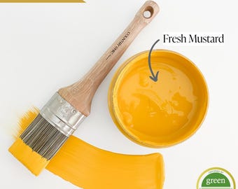 May include: A jar of Fresh Mustard paint, a bright yellow color, with a paintbrush and a paint stroke on a white background. The jar has a black label with the text "COUNTRY CHIC" and a green "greenwise GOLD" certification seal.