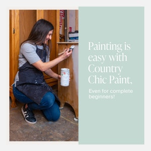 May include: A person paints a wooden cabinet with a white paint brush. The paint can is labeled "Country Chic Paint" and is sitting on the cabinet. The text "Painting is easy with Country Chic Paint, Even for complete beginners!" is on the right side of the image.