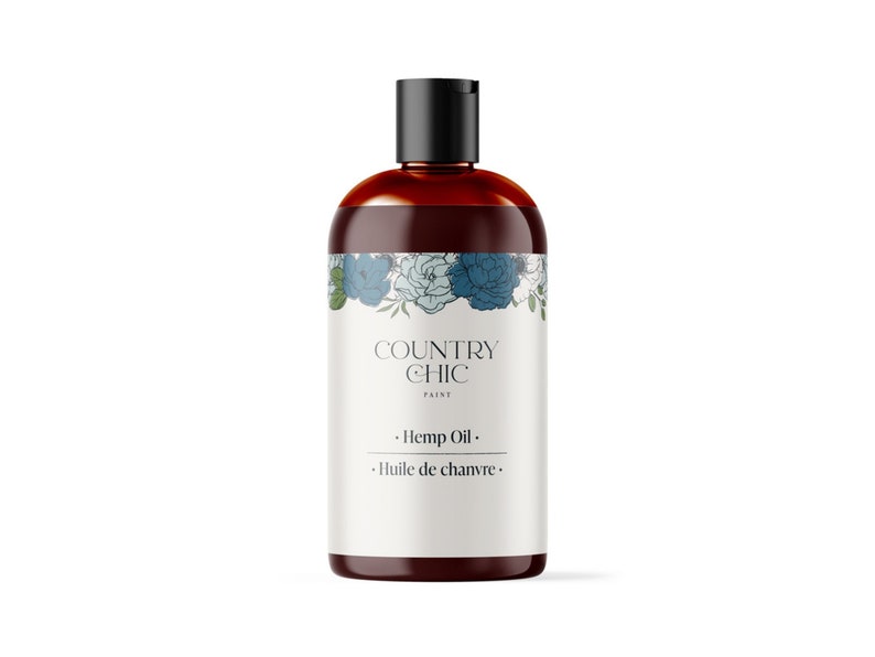 以下が含まれることがあります： 白いラベルに「COUNTRY CHIC PAINT」と「Hemp Oil. Huile de chanvre.」と書かれた茶色のガラス瓶。ラベルには青と緑の花の入った花柄のデザインが施されています。