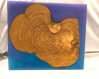 Live Edge Olive wood round surrounded by blue and purple resin Charcuterie Board
