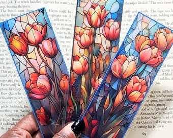 May include: Set of four colorful stained glass bookmarks featuring a floral design with red, yellow, and orange tulips. The bookmarks are made of clear plastic and have a blue border.