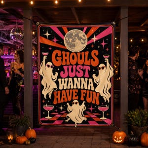 May include: A rectangular fabric banner featuring a black background with a retro-style graphic. It displays three white ghosts wearing pink sunglasses, holding pink cocktails, and dancing above a checkered floor. The text reads GHOULS JUST WANNA HAVE FUN in orange and pink, topped by a disco ball and starbursts.