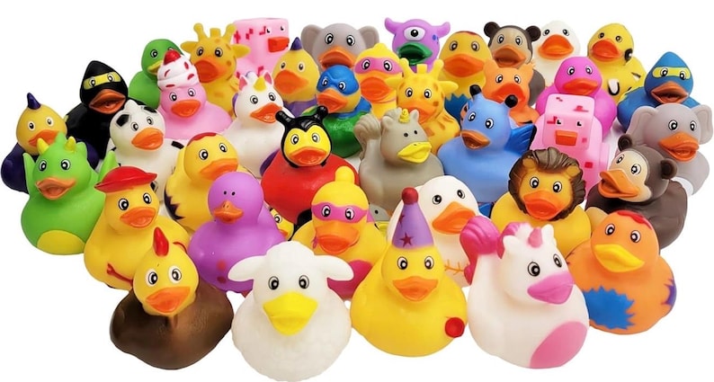 May include: A large collection of small rubber ducks featuring various designs, including animals like elephants, lions, and sheep, as well as characters with party hats, superhero masks, and unicorn horns in a wide array of bright, solid colors.