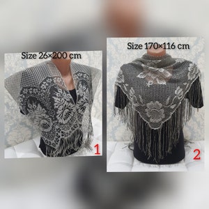 May include: Two gray lace shawls with fringe. The shawl on the left is 26 inches by 200 inches. The shawl on the right is 170 centimeters by 116 centimeters.