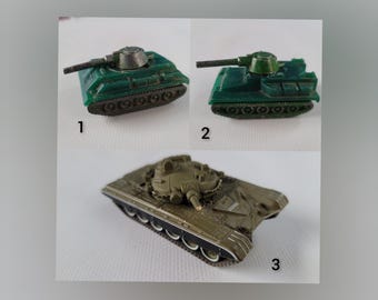May include: Three toy tanks, one green, one dark green, and one brown, with numbers 1, 2, and 3 underneath each.